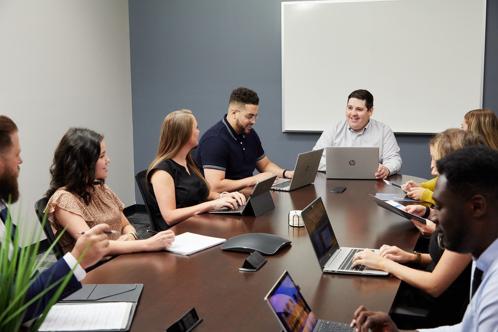 A group of people working together at a conference table